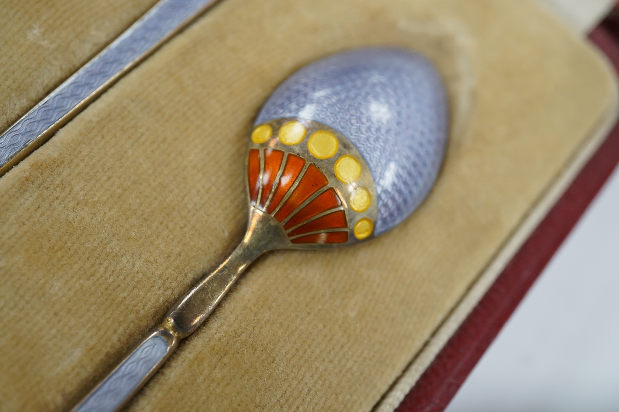 Two cased sets of six silver teaspoons, including enamelled. Condition - poor and good
